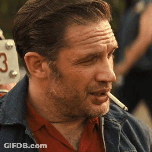 A Man Is Smoking A Cigarette In Front Of A License Plate That Says 3 GIF