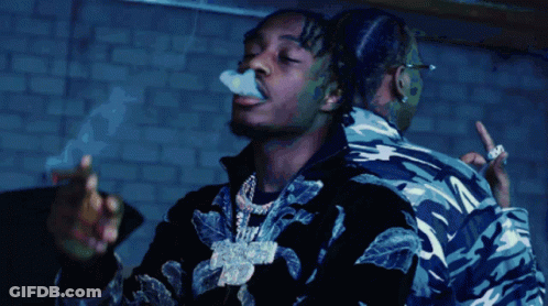 A Man Is Smoking A Cigarette While Another Man Looks On GIF