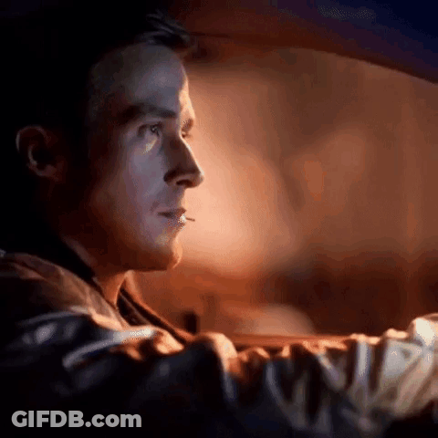 A Man Is Smoking A Cigarette While Driving A Car In The Dark . GIF