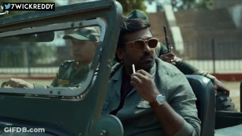 A Man Is Smoking A Cigarette While Sitting In A Car With Wickreddy Written On The Bottom GIF