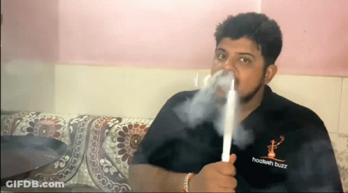 A Man Is Smoking A Hookah While Wearing A Hookah Buzz Shirt . GIF