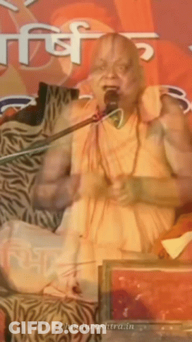 A Man Is Speaking Into A Microphone And The Website Behind Him Says ' Ohindurashtra.in ' GIF