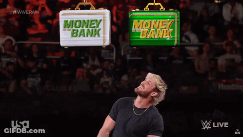 A Man Is Speaking Into A Microphone In Front Of A Sign That Says Money In The Bank GIF
