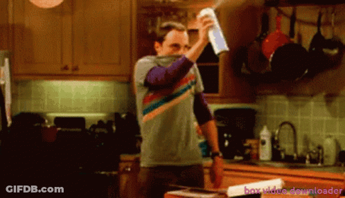A Man Is Spraying Something In A Kitchen With The Words Box Video Downloader Behind Him GIF