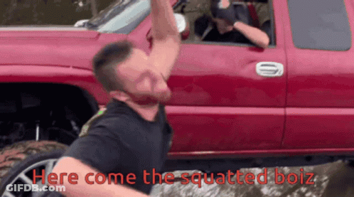 A Man Is Squatting In Front Of A Red Truck With The Words Here Come The Squatted Boiz Below Him GIF