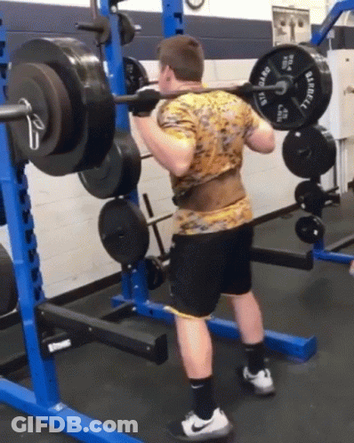 A Man Is Squatting With A Barbell That Says Barbell On It GIF