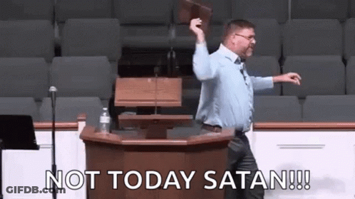 A Man Is Standing At A Podium Holding A Bible And Saying `` Not Today Satan '' . GIF