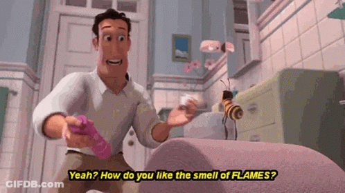 A Man Is Standing In A Bathroom Talking To A Bee While Holding A Remote Control . GIF
