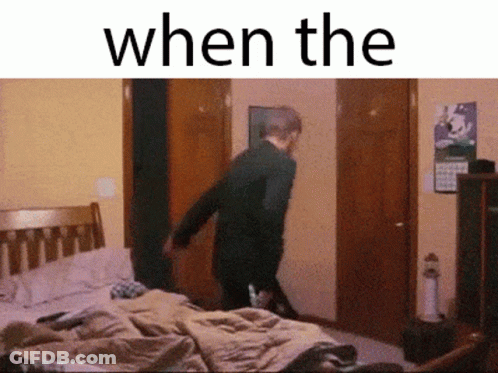 A Man Is Standing In A Bedroom With The Words " When The " Written Above Him GIF