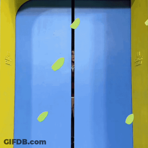 A Man Is Standing In A Blue And Yellow Doorway With A Heart On It GIF