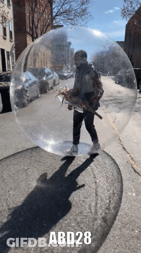 A Man Is Standing In A Clear Bubble With Abd28 Written On The Bottom GIF