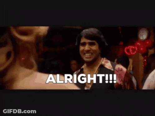 A Man Is Standing In A Crowd With The Word Alright Written On The Screen GIF