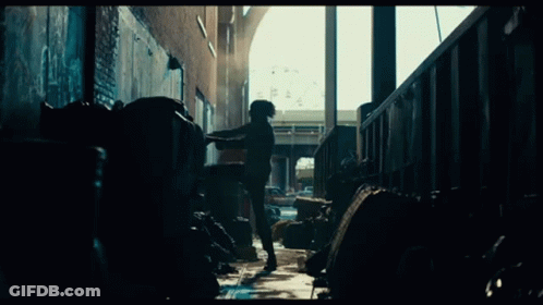 Man Standing In Dark Alley With Trash GIF
