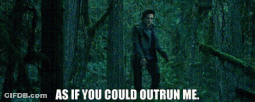 A Man Is Standing In A Dark Forest With The Words As If You Could Outrun Me GIF