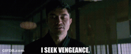 A Man Is Standing In A Dark Room And Saying `` I Seek Vengeance . '' GIF