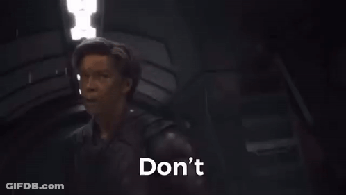 A Man Is Standing In A Dark Room With His Hand Out And The Words `` Do N't Be Rash '' . GIF