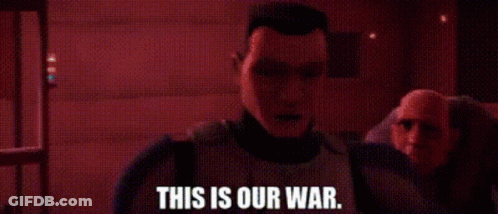 A Man Is Standing In A Dark Room With The Words `` This Is Our War '' Written On It . GIF