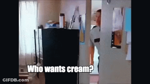 A Man Is Standing In A Doorway Asking Who Wants Cream . GIF