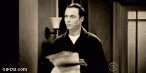 A Man Is Standing In A Doorway Holding A Stack Of Papers In His Hand . GIF
