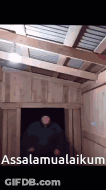 A Man Is Standing In A Doorway With The Words Assalamualaikum Written On The Bottom GIF