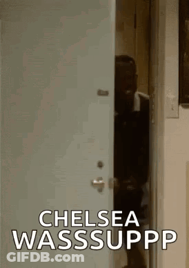 A Man Is Standing In A Doorway With The Words `` Chelsea Wasssuppp '' Written On It . GIF