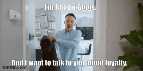 A Man Is Standing In A Doorway With The Words I 'M Rhodri Giggs GIF