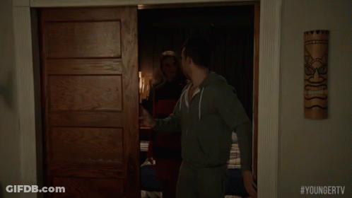 A Man Is Standing In A Doorway With #Youngertv Written On The Bottom Of The Screen GIF