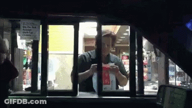 A Man Is Standing In A Drive Thru Window With A Sign That Says We Do Not Accept Credit Cards GIF