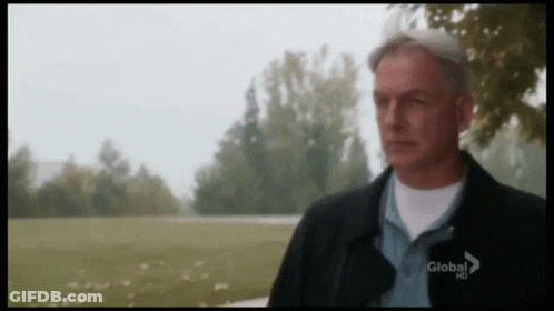 A Man Is Standing In A Field With A Global Hd Logo On The Bottom Right GIF