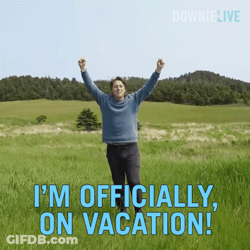 A Man Is Standing In A Field With His Arms In The Air And The Words " I 'M Officially On Vacation " GIF