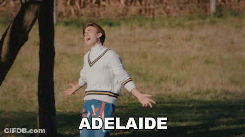 A Man Is Standing In A Field With The Word Adelaide Written On The Bottom GIF