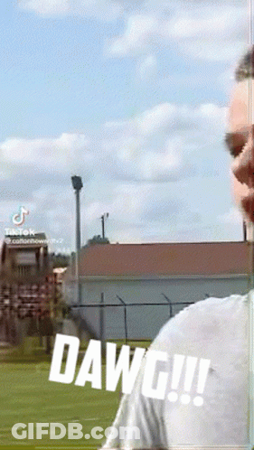 A Man Is Standing In A Field With The Word Dawg Written On The Bottom GIF