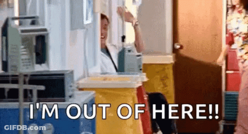 A Man Is Standing In A Hospital Room Talking On A Cell Phone And Says `` I 'M Out Of Here '' . GIF