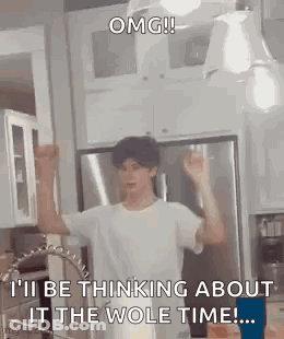 A Man Is Standing In A Kitchen With His Arms In The Air And A Sink . GIF