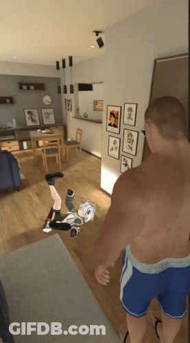 A Man Is Standing In A Living Room With A Girl On The Floor GIF