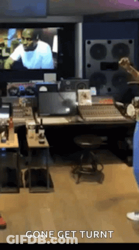 A Man Is Standing In A Recording Studio With The Words Gone Get Turnt On The Bottom Of The Screen . GIF