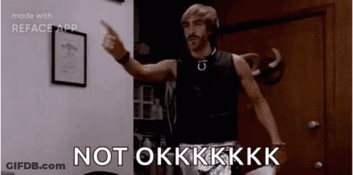 A Man Is Standing In A Room Pointing At The Camera And Saying `` Not Okkkk '' . GIF