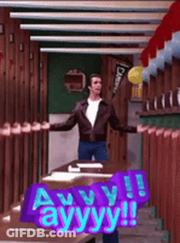 A Man Is Standing In A Room With A Sign That Says Ayyy ! GIF