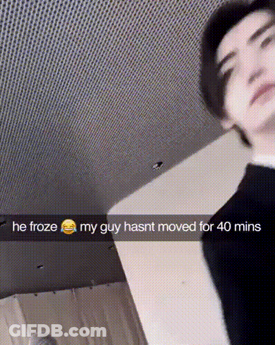 A Man Is Standing In A Room With A Snapchat Caption That Says He Froze My Guy Hasnt Moved For 40 Mins GIF