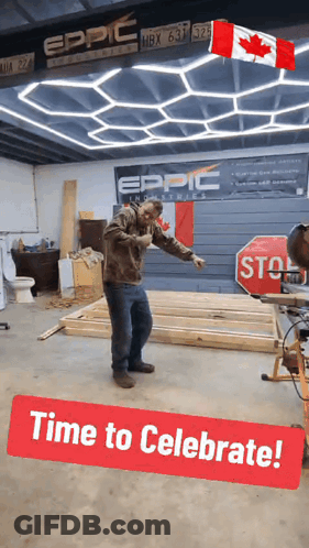 A Man Is Standing In A Room With A Stop Sign And A Sign That Says Time To Celebrate GIF