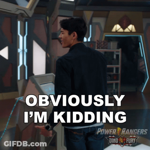 A Man Is Standing In A Room With The Words Obviously I 'M Kidding On The Bottom GIF