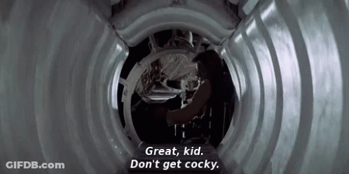 A Man Is Standing In A Tunnel And Talking To Another Man . GIF