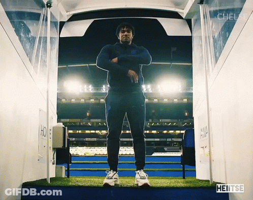 A Man Is Standing In A Tunnel That Says Heitse On The Bottom GIF