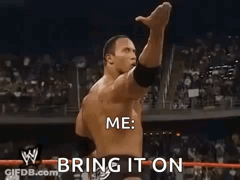 A Man Is Standing In A Wrestling Ring With His Fist In The Air . GIF