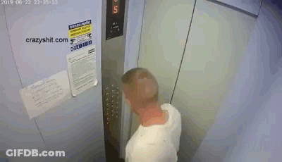 A Man Is Standing In An Elevator With A Sign On The Wall That Says ' Warning ' GIF