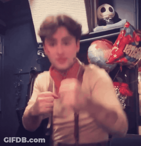 A Man Is Standing In Front Of A Balloon That Says Levis On It GIF