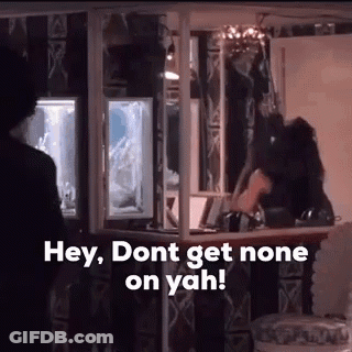 A Man Is Standing In Front Of A Bar With The Words `` Hey , Don T Get None On Yah '' . GIF