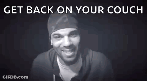 A Man Is Standing In Front Of A Black Background With The Words `` Get Back On Your Couch # Blocked '' . GIF