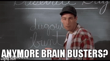A Man Is Standing In Front Of A Blackboard With Writing On It . GIF