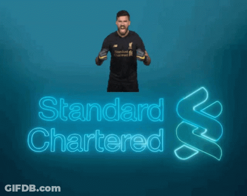 A Man Is Standing In Front Of A Blue Background That Says Standard Chartered GIF